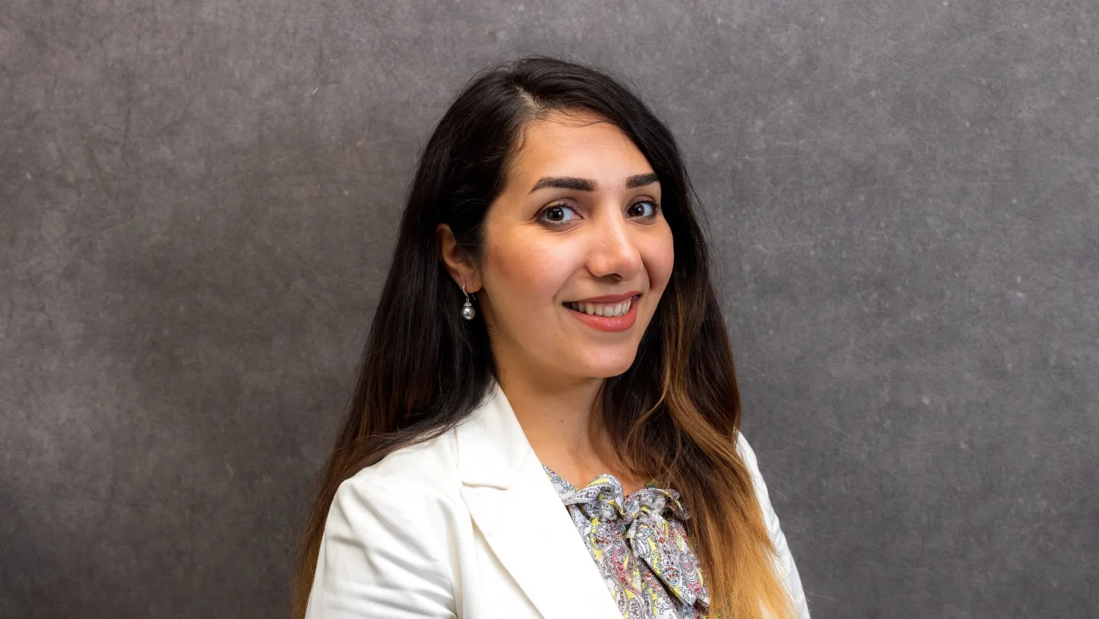 Professional headshot of a woman on a plain backdrop, an example of the finished result