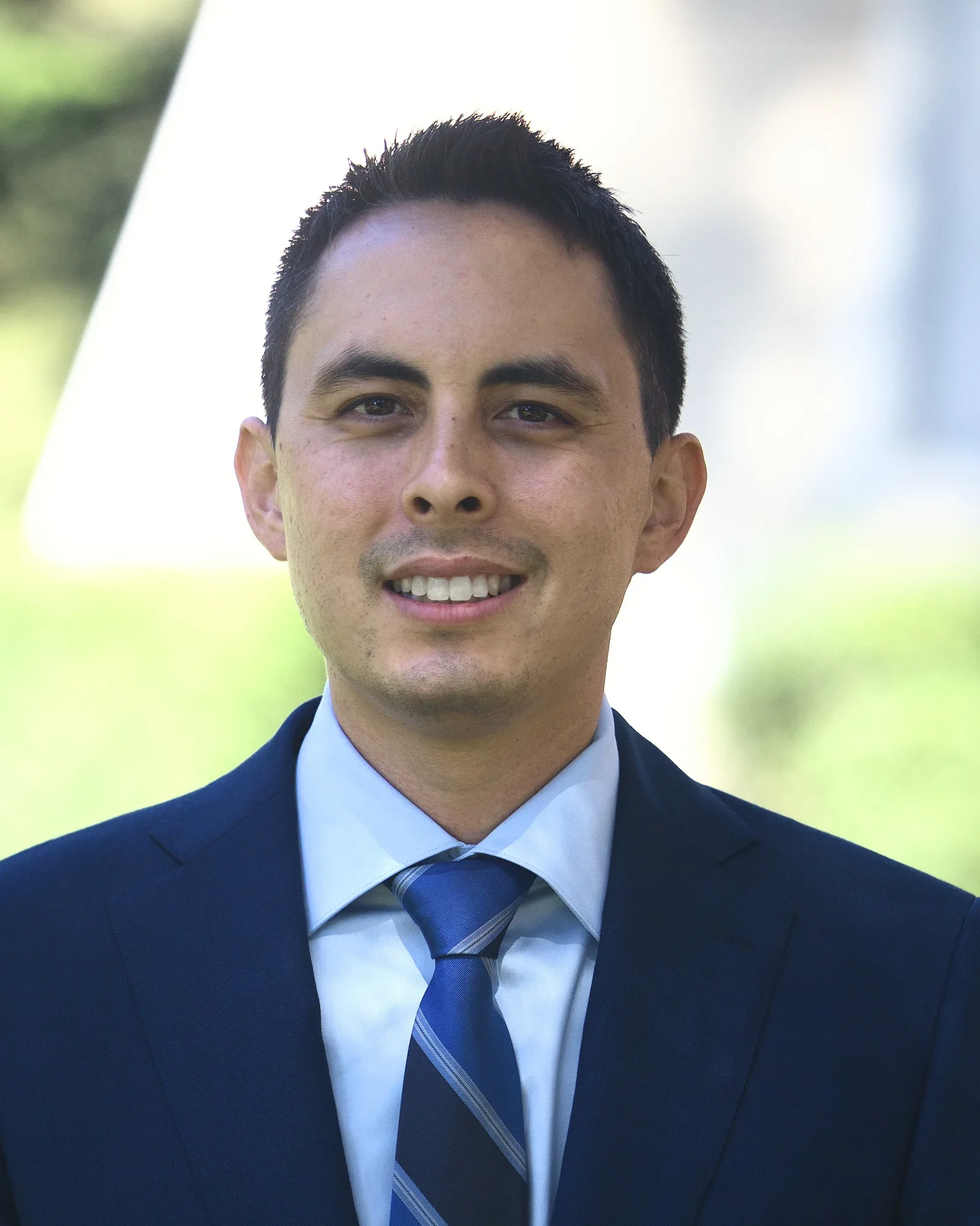 Professional headshot of a man, consistent lighting and framing