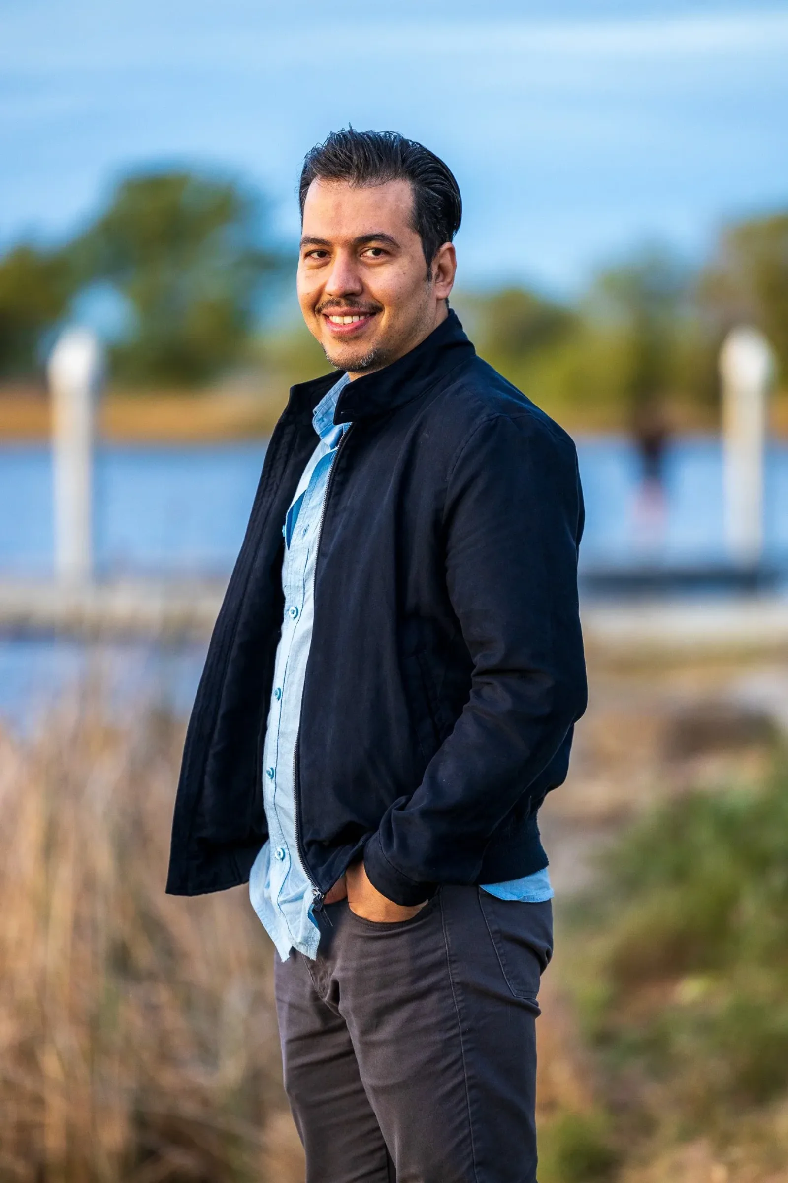 Professional headshot of a man in a blue blazer