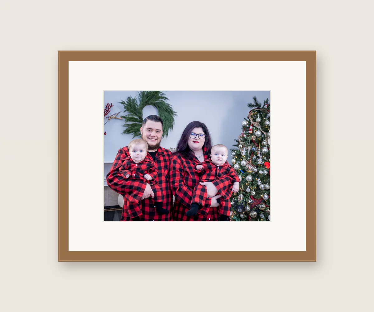 Framed 11x14 of a family in matching red flannel by the Christmas tree